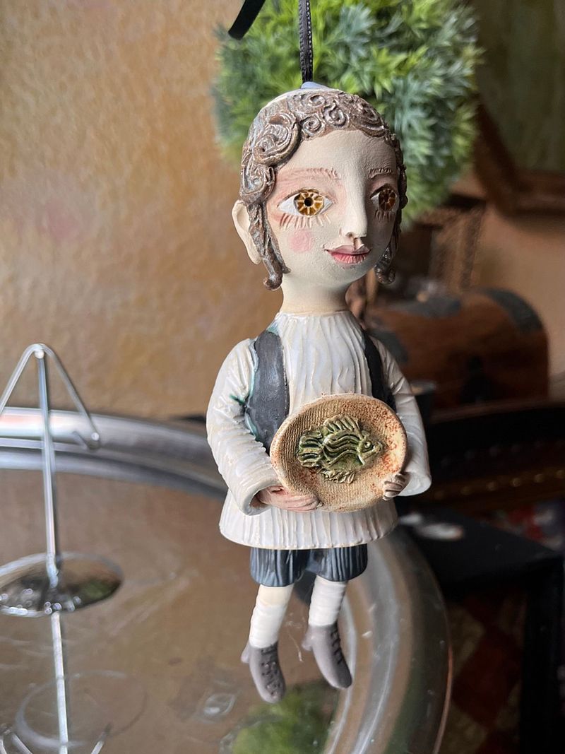 Traditional boy with a fish, little ceramic hanging sculpture