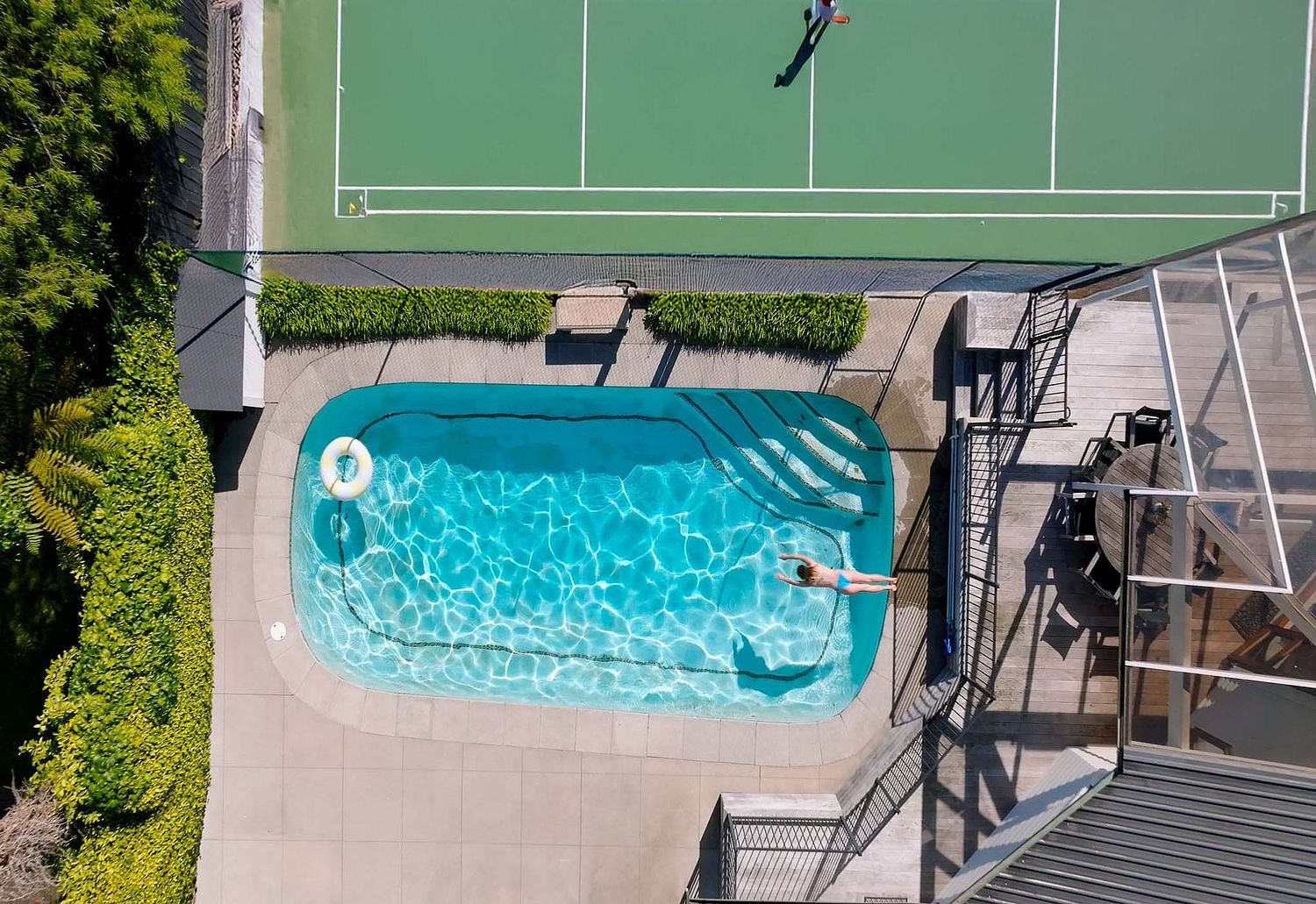 Cinematic drone photography of a luxury central Hamilton home and pool by Flax Cove Studio