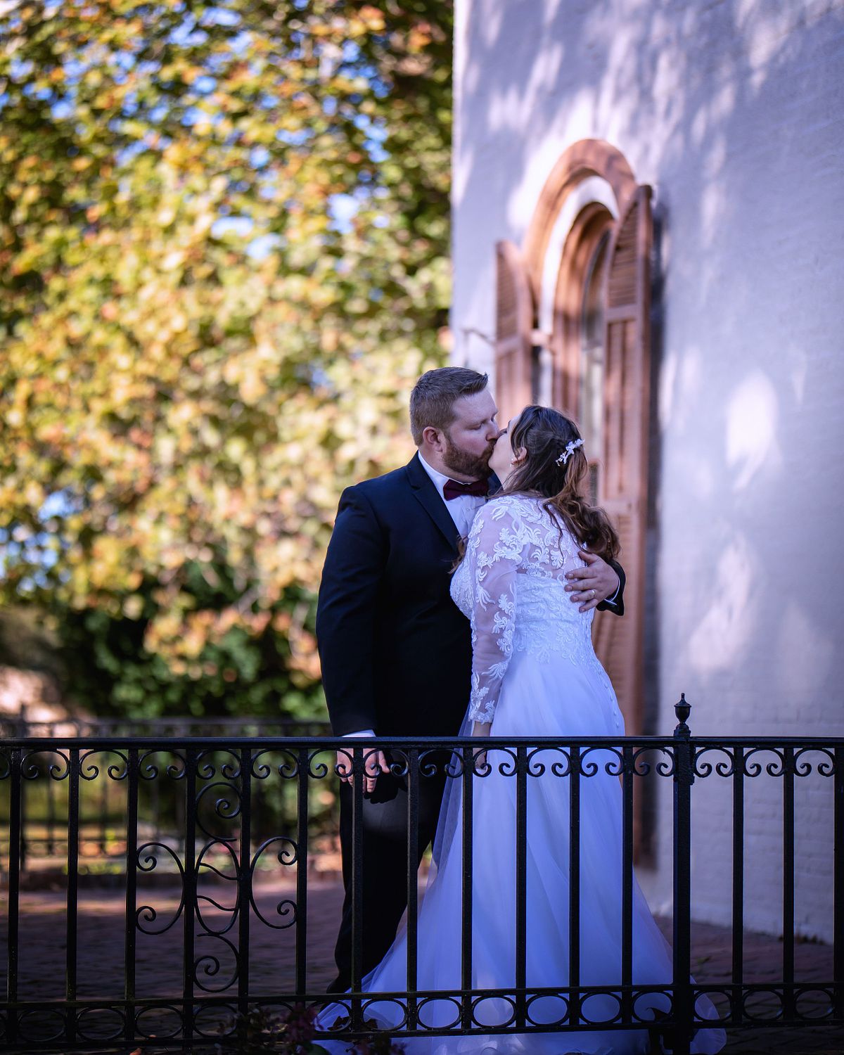 Detailed view of the Victorian veranda at the Ross Mansion, curated by the Seaford Historical Society for historic weddings, with bride and groom standing on veranda kissing