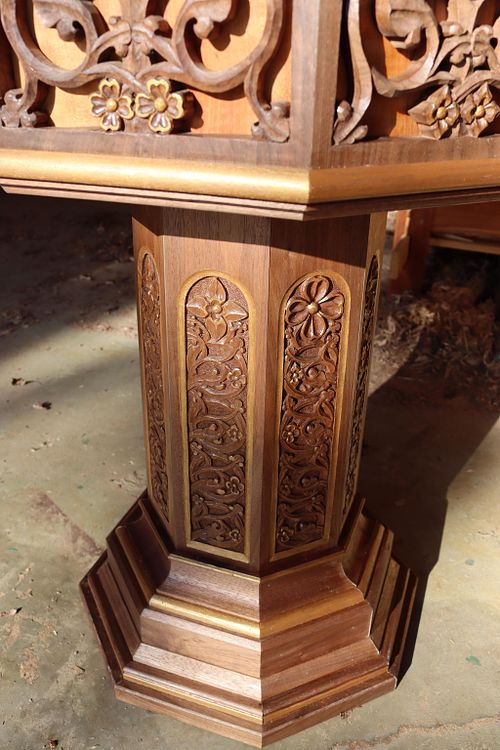 detail of the stem and base moldings of the hand carved walnut baptismal font
