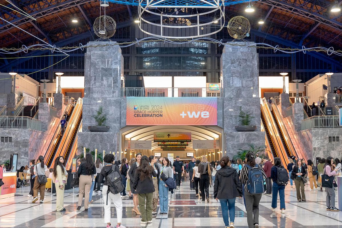 Conference photography capturing attendees entering the Pennsylvania Convention Center for the 2024 Grace Hopper Celebration in Philadelphia, showcasing diversity, connection, and authentic moments in corporate spaces.