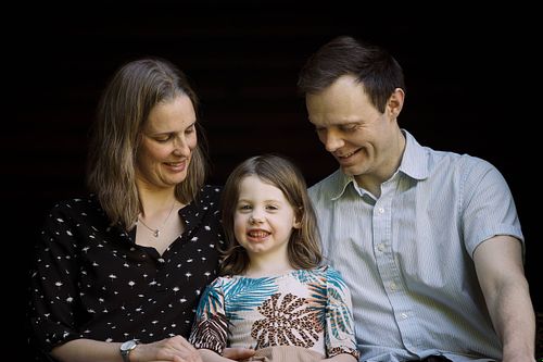 A family sitting on a window sill in a barn in Chapel Hill, NC