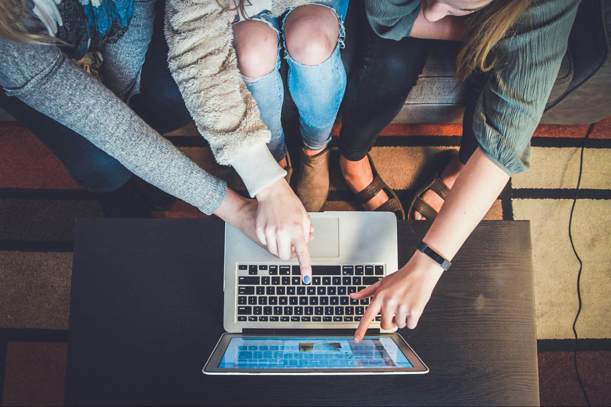 3 people watching a laptop screen