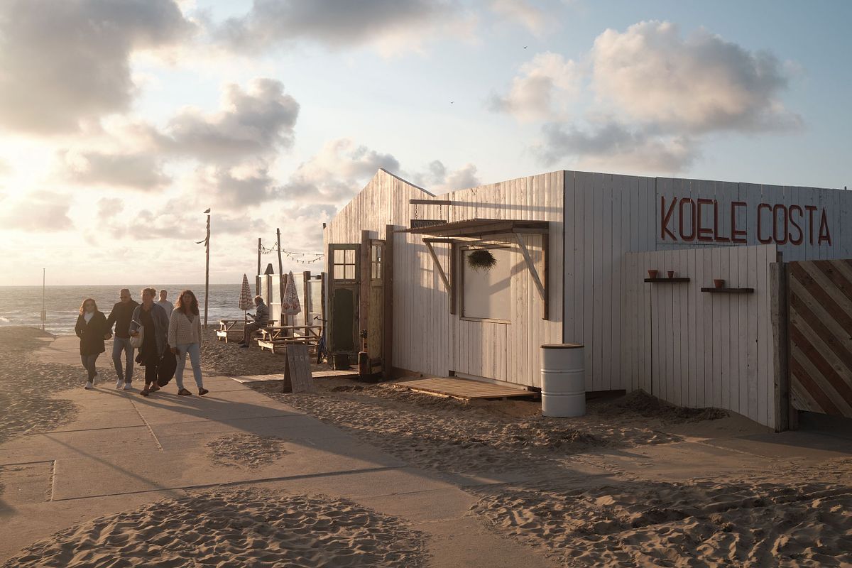 People walking past Koele Costa Beach Café during sunset, captured by photographer Sandeep Gajula