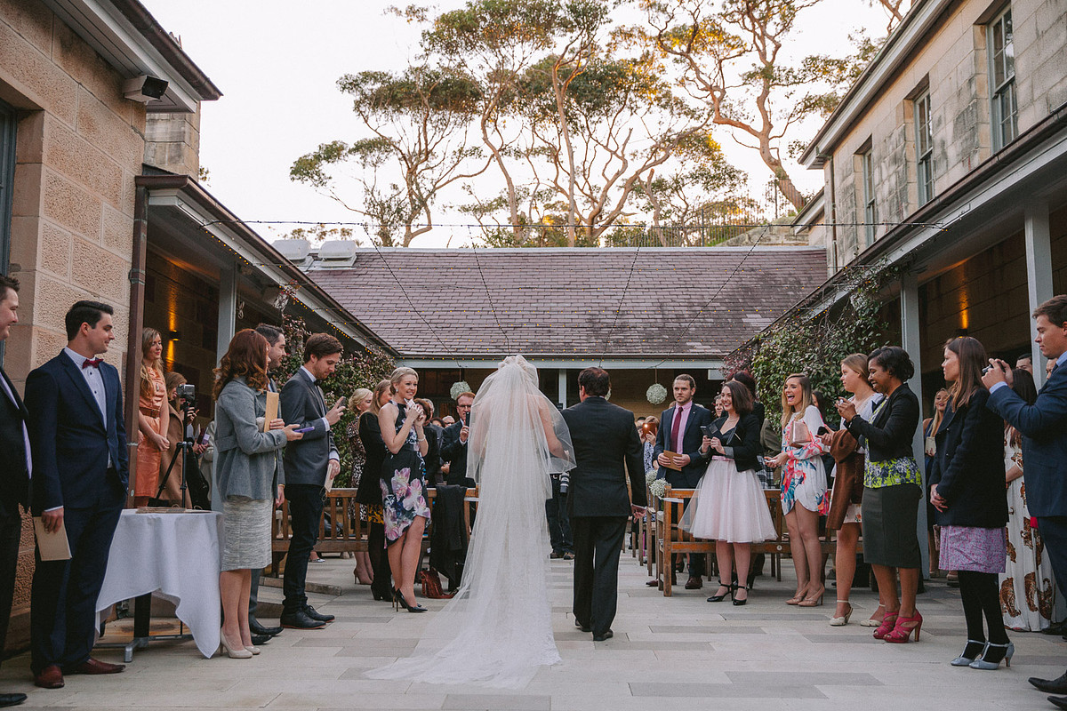 Bride is walking down the aisle during a wedding ceremony at Gunners Barracks Mosman.