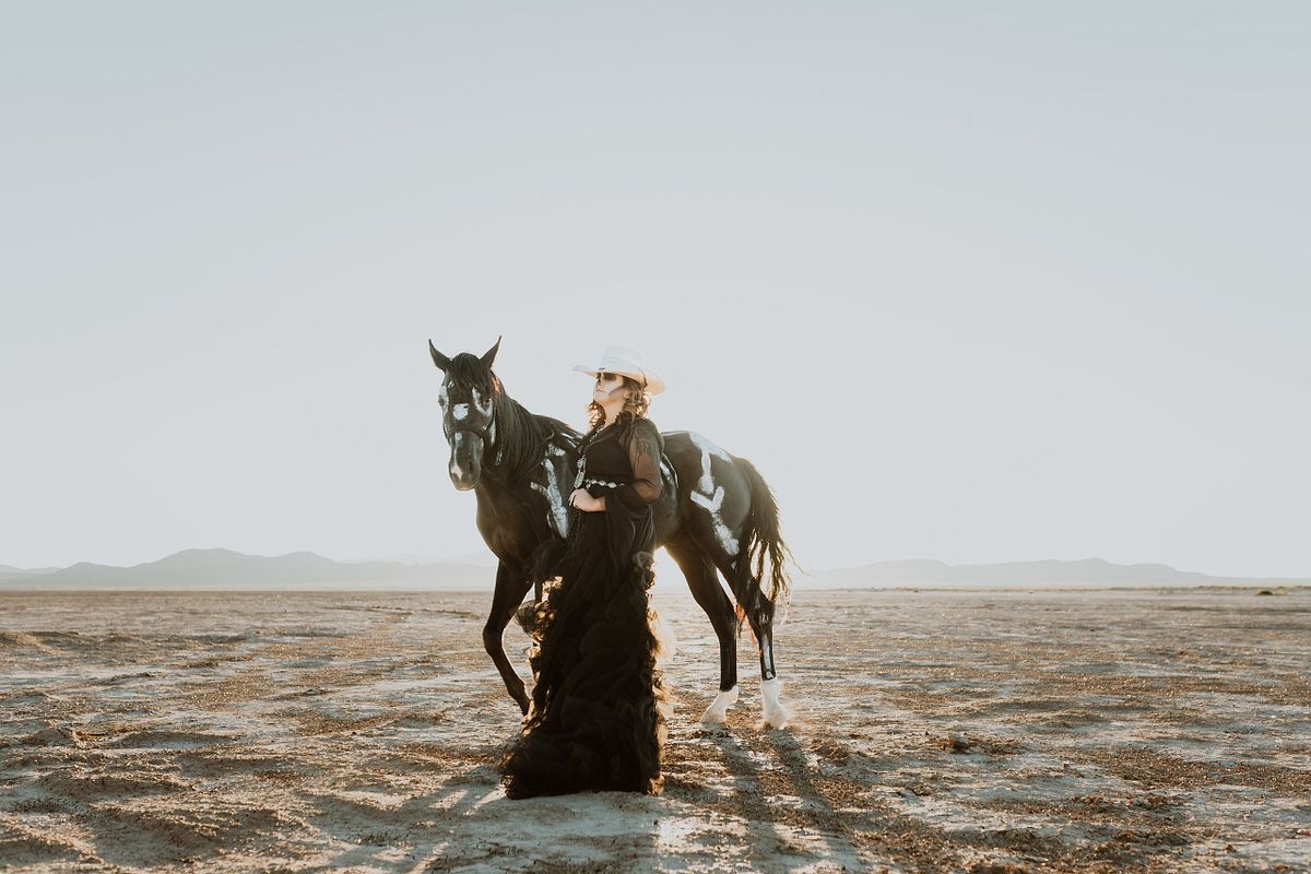 Bold, moody Halloween portrait featuring dramatic skull makeup and costume elements.