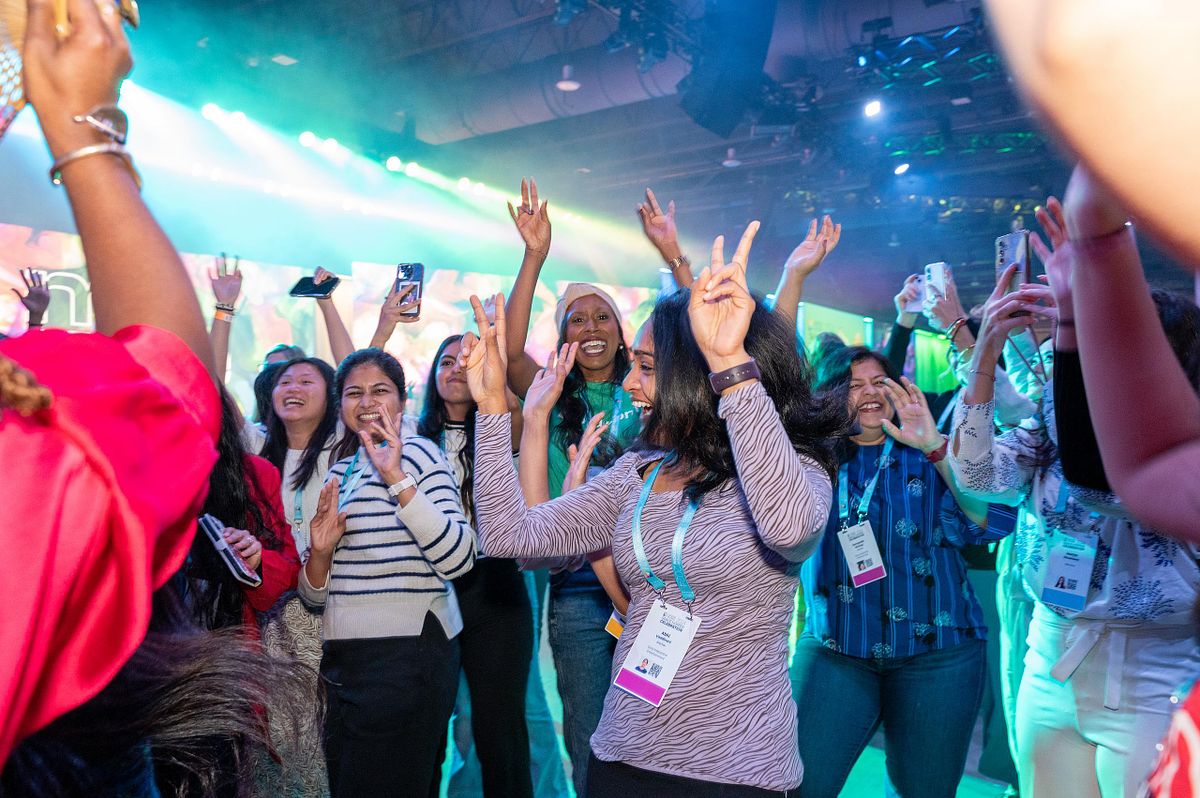Corporate event photography capturing Grace Hopper Celebration attendees dancing and celebrating during an after-hours event, highlighting joy, community, and connection in Philadelphia.