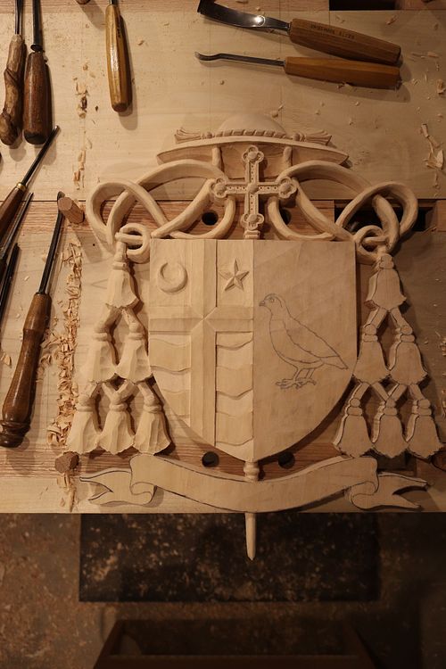 dexter side of coat of arms is carved