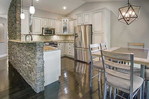 Wide-angle residential kitchen interior with clean architectural lines and natural light