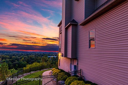 Luxury residential real estate photography at twilight with dramatic sunset sky colors