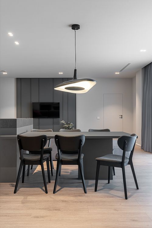 Minimalist dining area in an open-plan space with muted tones &ndash; Columna project