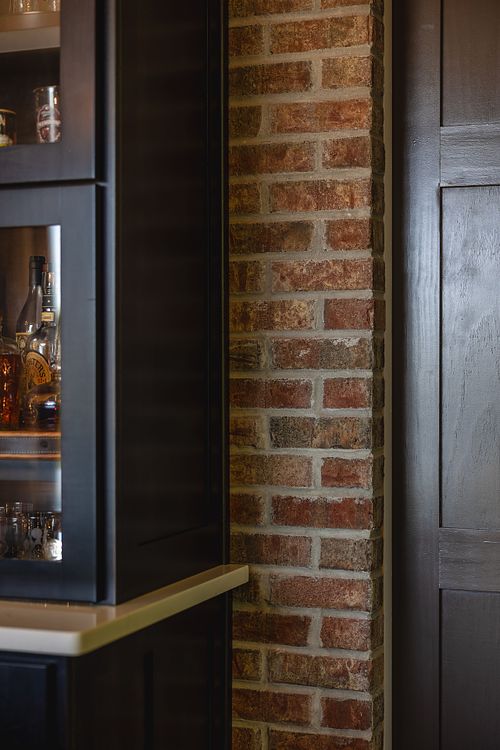 Brick; Charcoal color cabinet; pocket door frame; wood pocket door