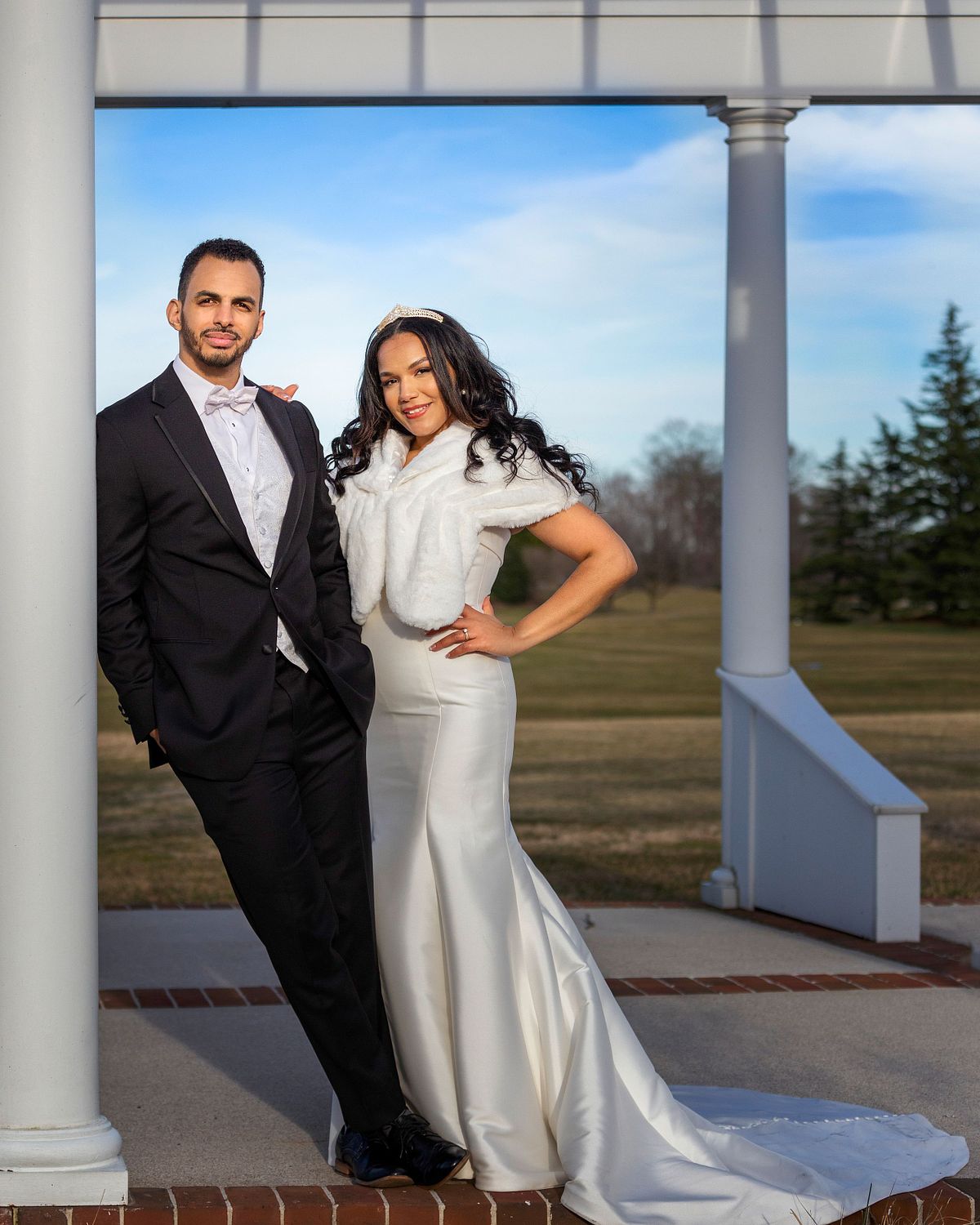bride and groom posing at baywood greens golf course and club house