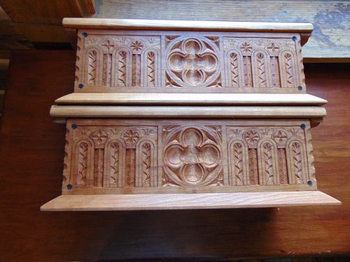 both boxes next to each other showing the carving on their faces