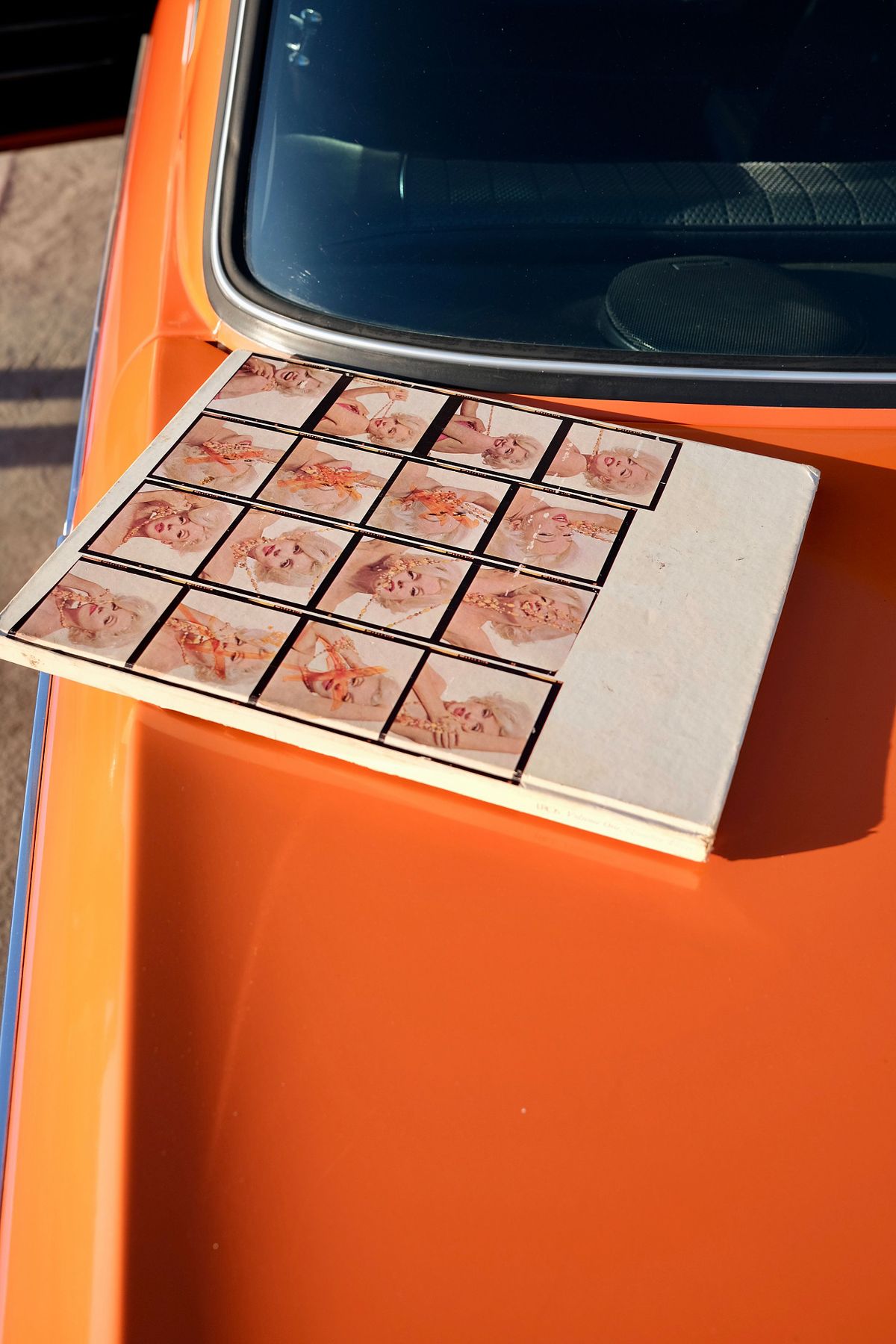 Marilyn Monroe book left on an inca orange classic car