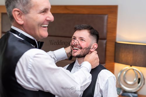Wedding by Jermaine – father of the groom adjusting the groom's collar before the wedding