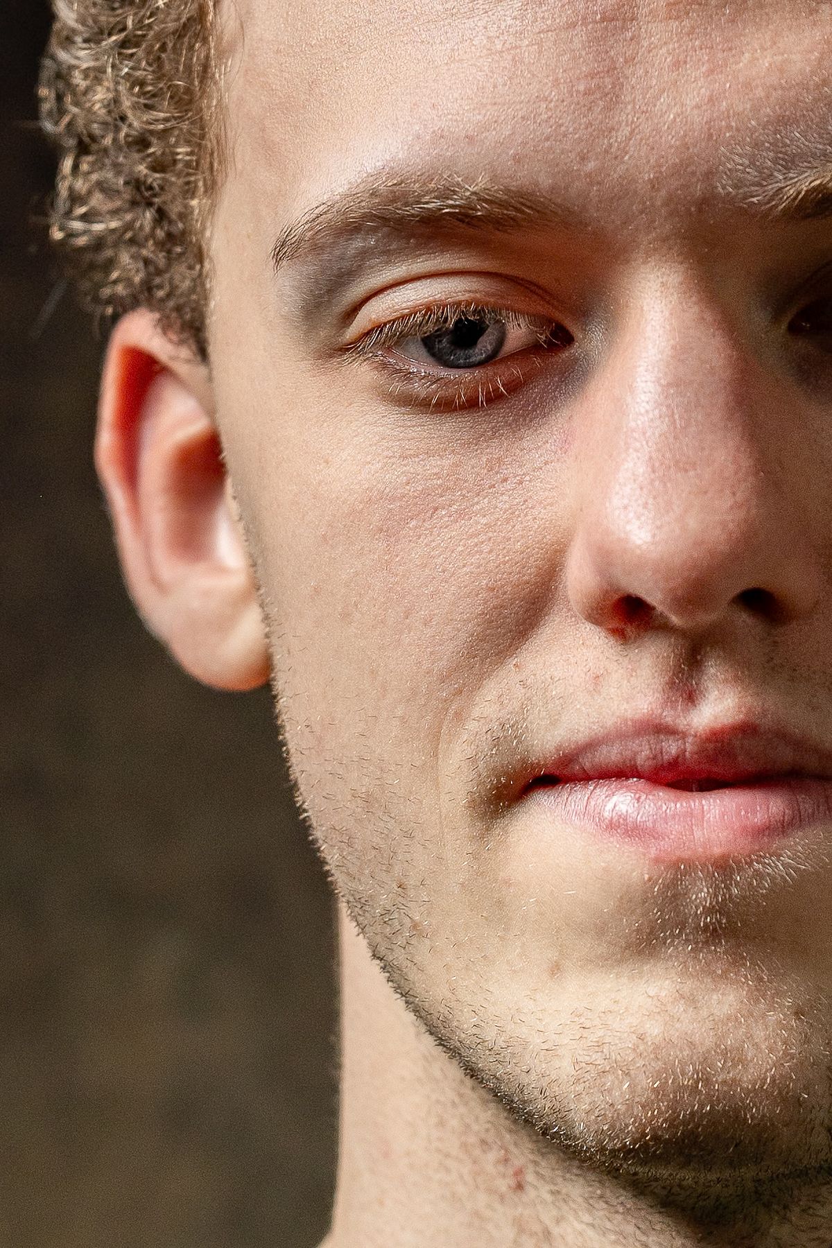 Extreme close-up portrait of a young man&rsquo;s face with detailed skin texture, photographed in Stockholm by Mats Karlsson.
