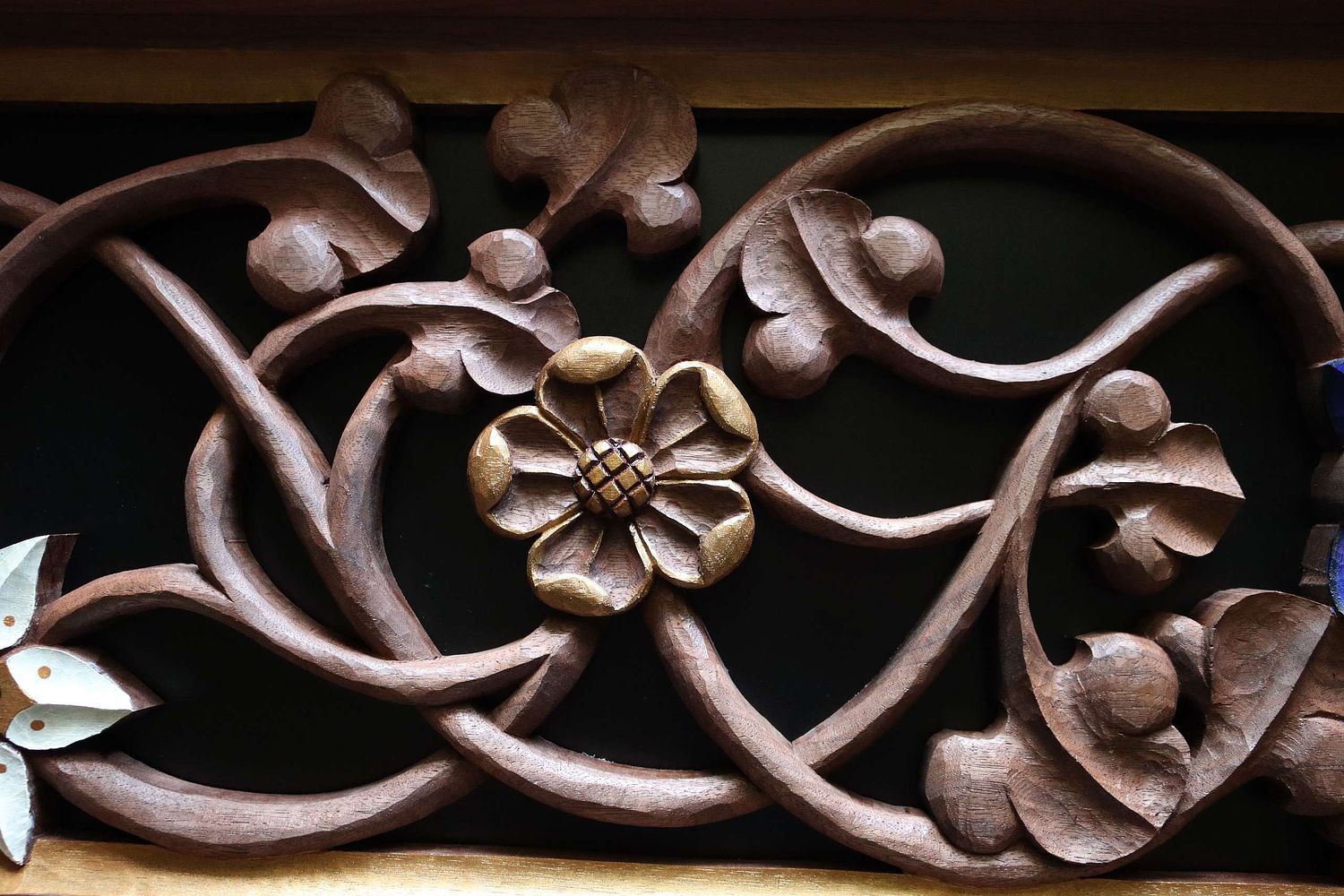 hand-carved wild rose with gold paint