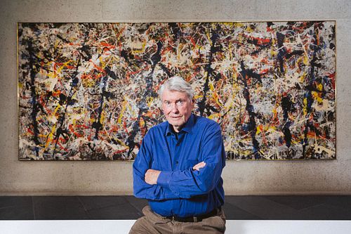 Art Dealer Denis Savill sit's infront of Jackson Pollock's Blue Poles at the National Gallery of Australia.
