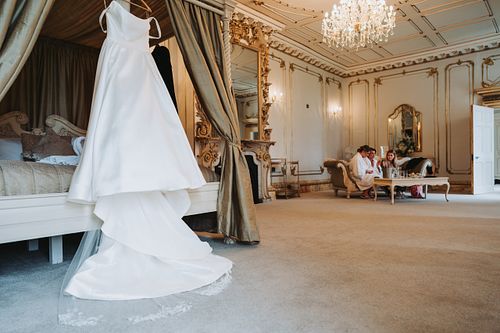 Brides dress in getting ready room