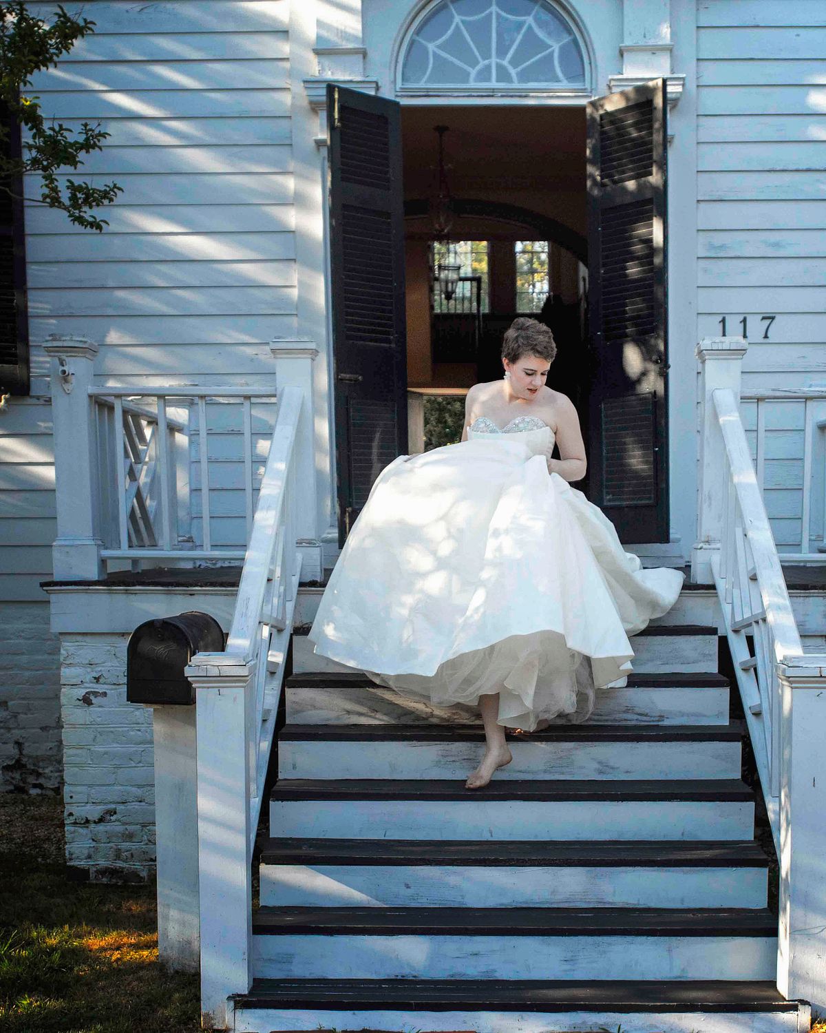 a bride running down the stairs at poplar Hill in Salisbury, md