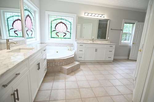 Illuminated bathroom with stained glass,and soaking tub