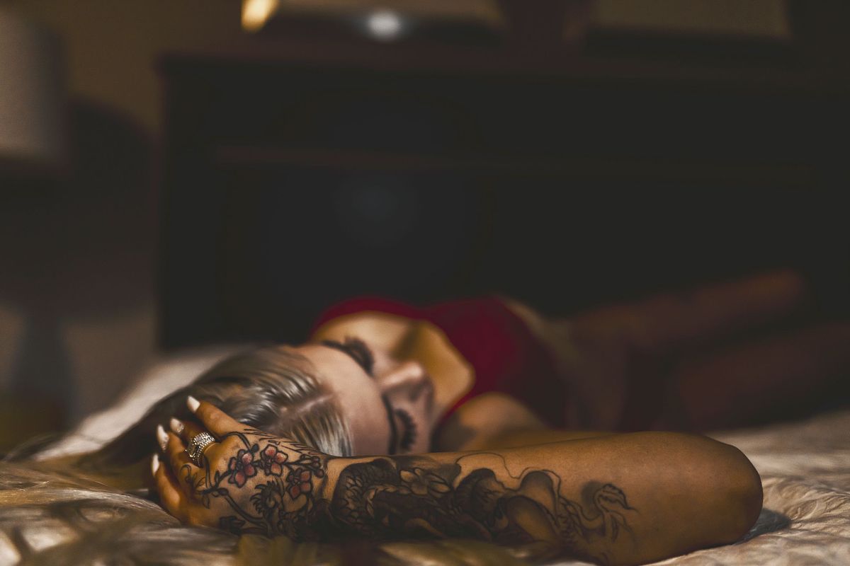 Empowering boudoir portrait with confident pose and soft lighting