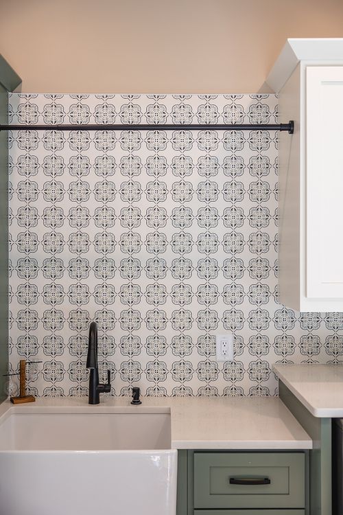 Laundry hanging area and farmhouse style sink in laundry room