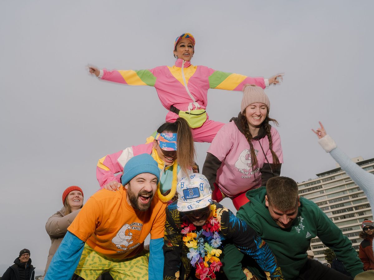 funny people make a pyramid on a Vancouver beach event