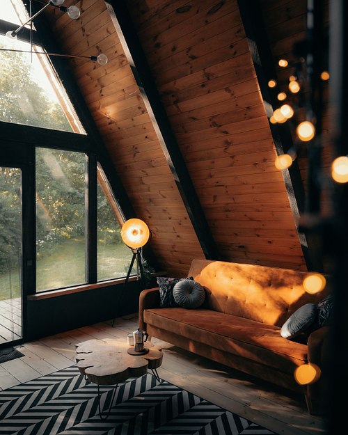 Warm wooden cabin interior with soft light and cozy slow living atmosphere