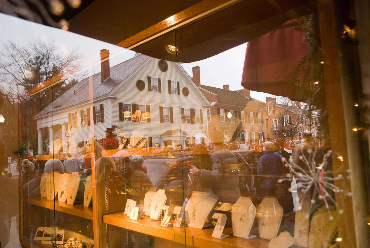 Main street parade reflected in jewelry store window in Woodstock Vermont