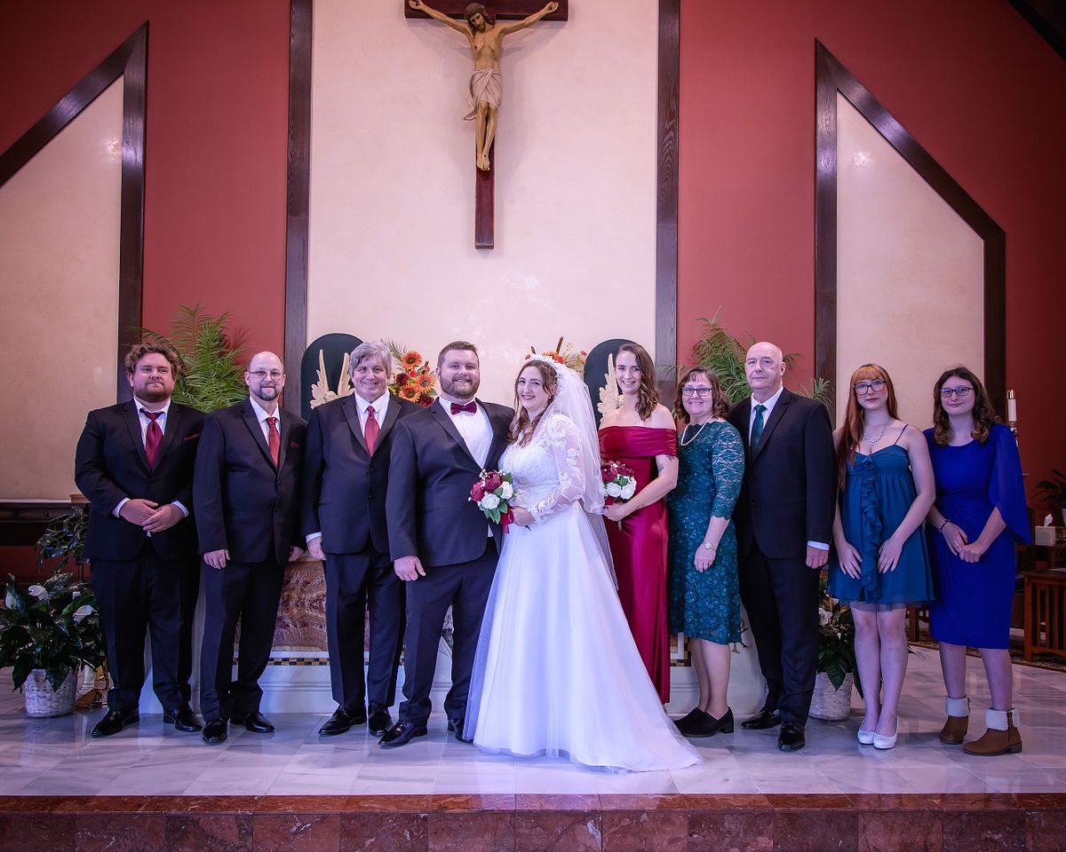 family portrait after catholic wedding ceremony at st. lukes parish, lewes, delaware