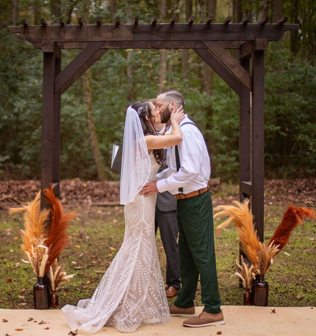 bride and groom kissing after the ceremony during a forest weddin