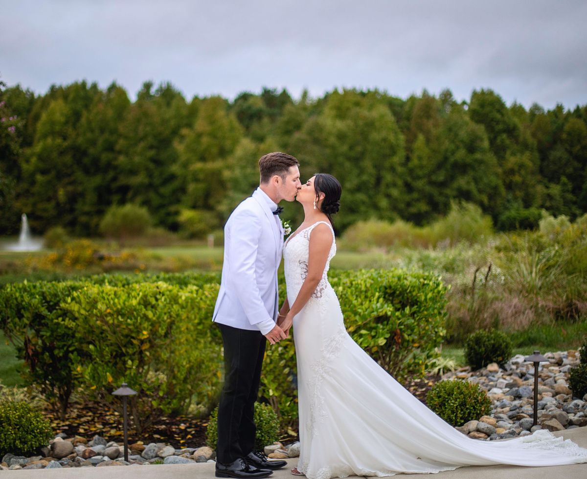 bride and groom kissing on the terrace at kylan barn