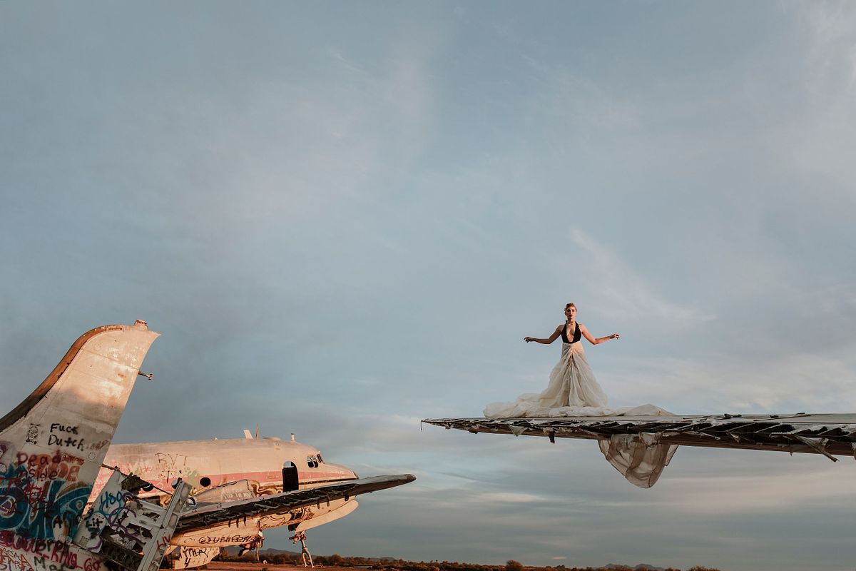 portrait of a woman posing powerfully on an abandoned airplane in the Arizona desert
