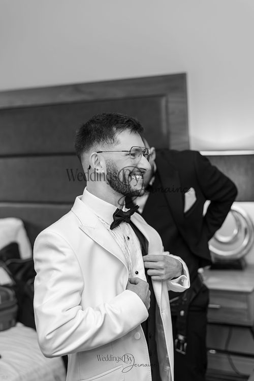 Wedding by Jermaine – black and white photo of the groom getting ready for his wedding day