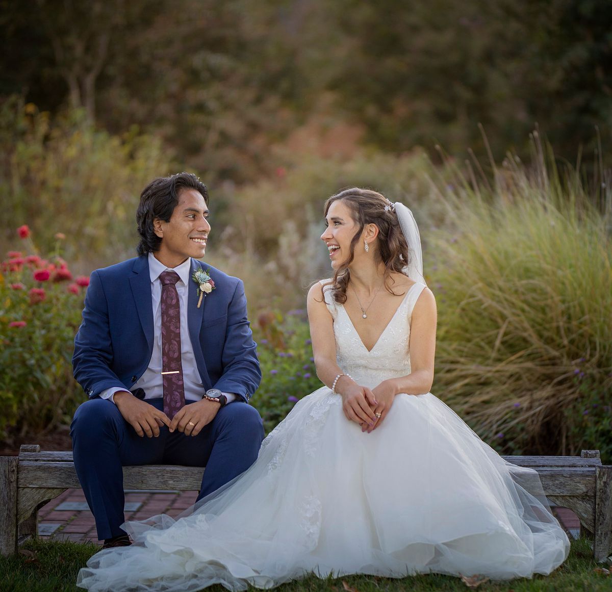 Newly wed couple sitting on bench at the lewis ginter botanical garden