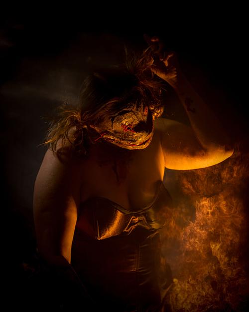 The voodoo doll dancing in the light of a fire.