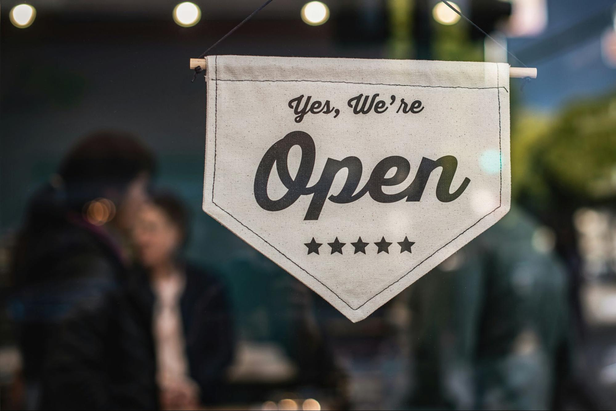 image on a store that reads "we are open"