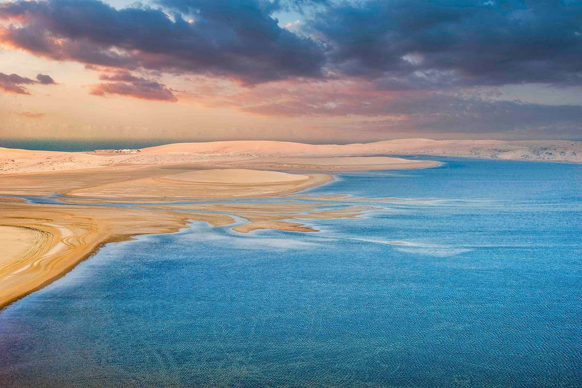 Sand Dunes Meet The Inland Sea in Qatar