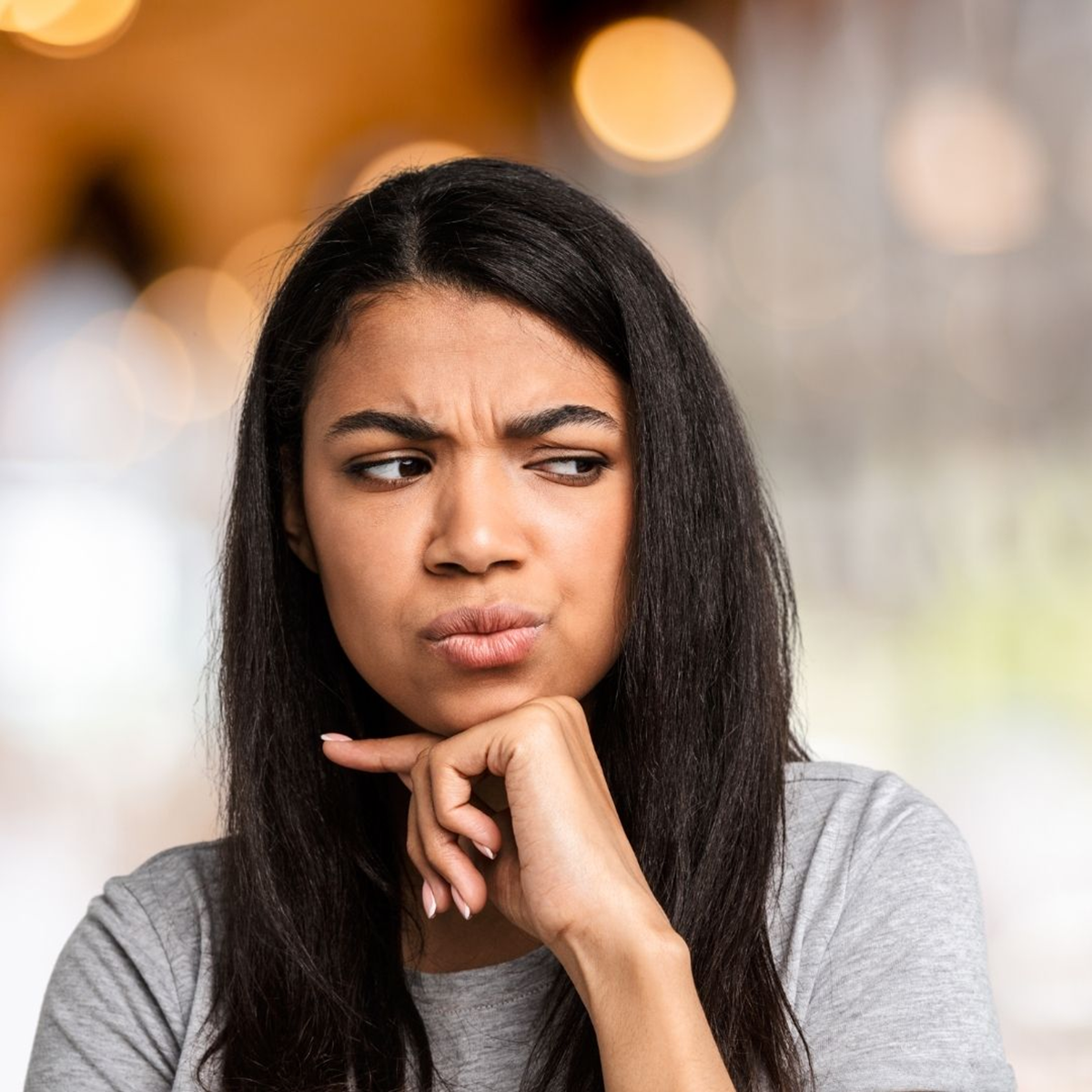 woman looking worried about her facial twitch affecting her mouth