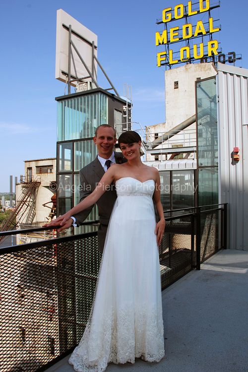A bride and groom pose on a rooftop in the Twin Cities