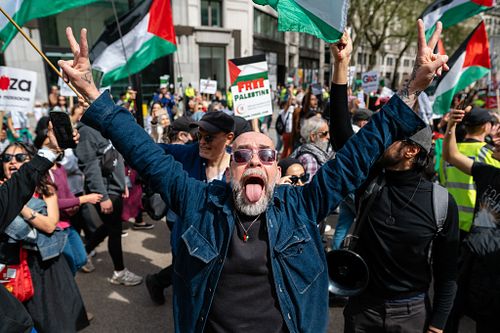 Pro-Palestine supporters march by a Pro-Israeli counter protest, London, UK
