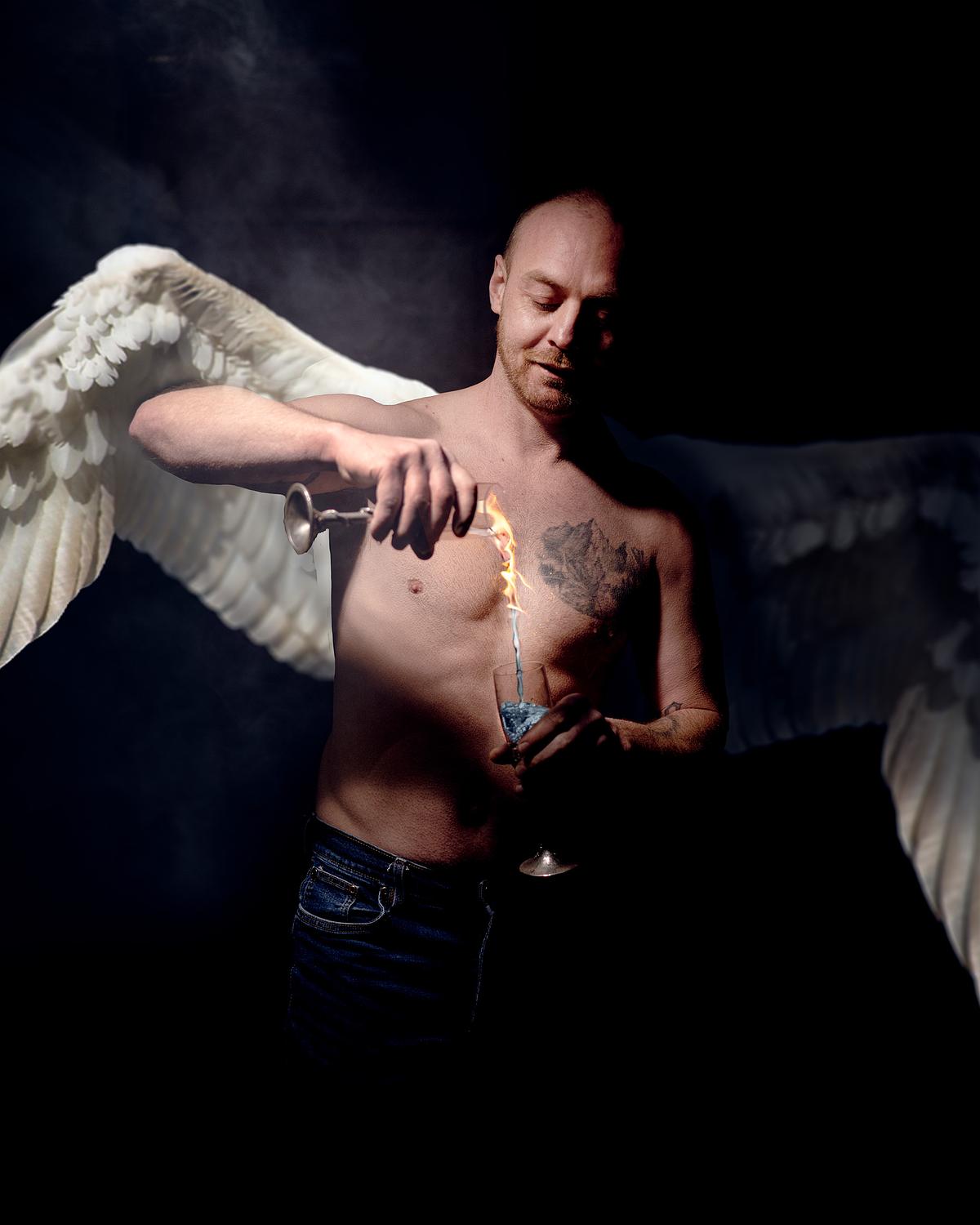 An angel turning fire into water as it pours from one goblet to another.