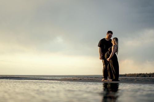 Sunset portrait of pregnant couple.