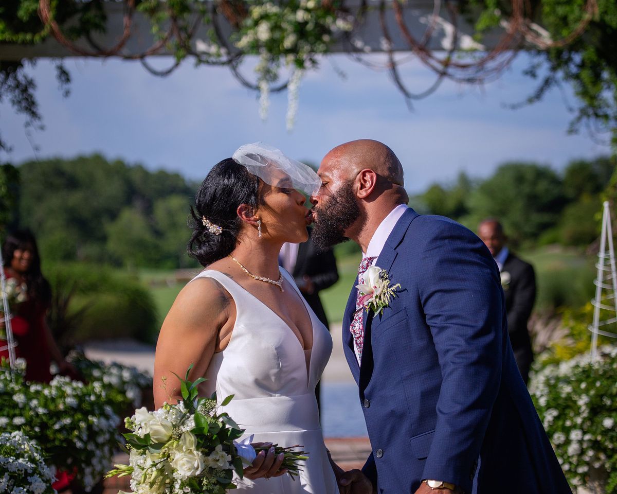 bride and groom kissing after the ceremony under the gazebo