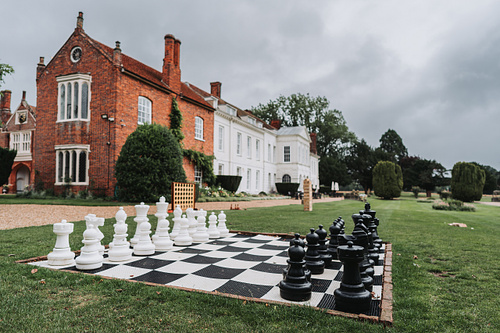 Chess board on grass and venue