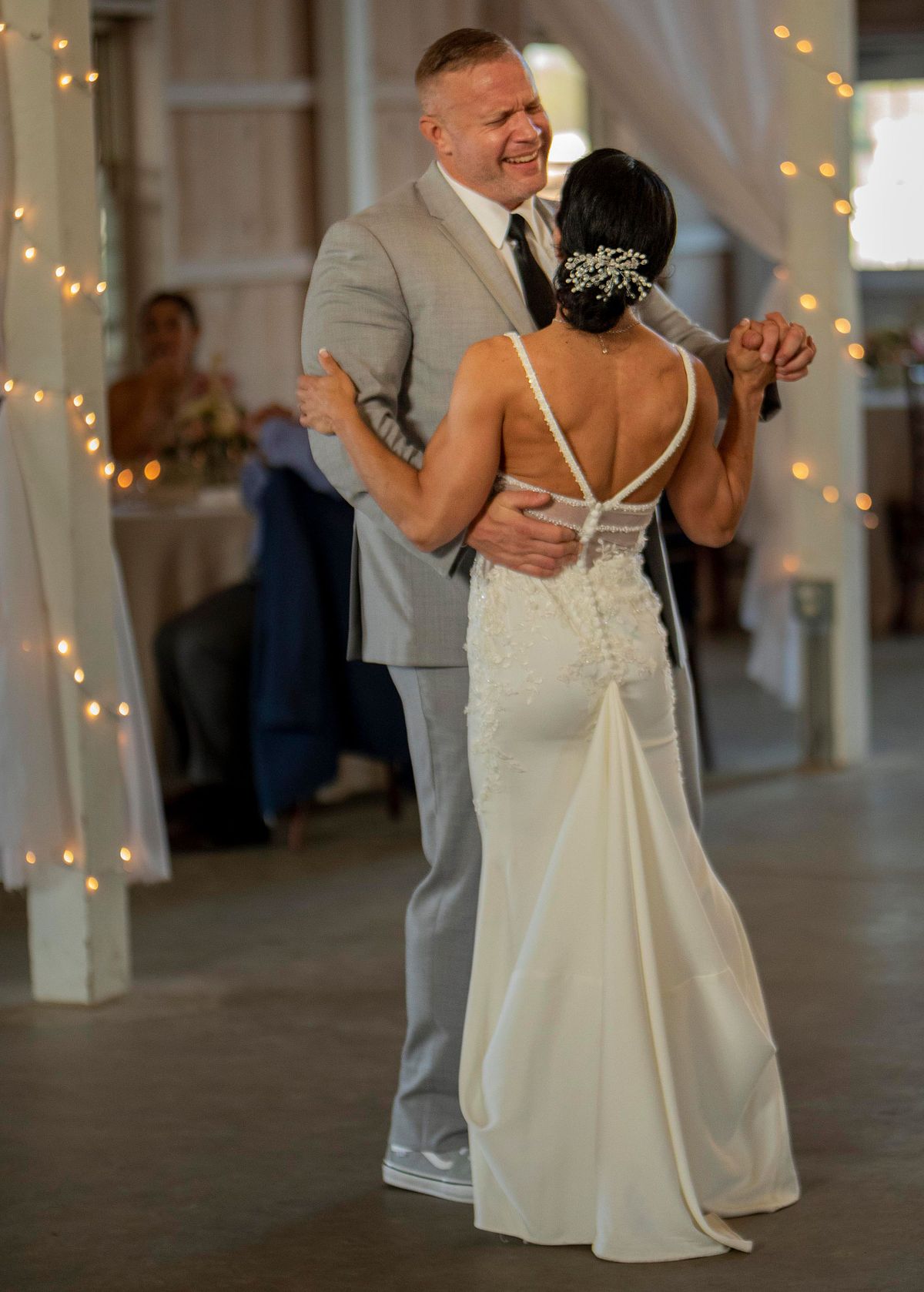 groom singing to his wife during the first dance inside kylan barn