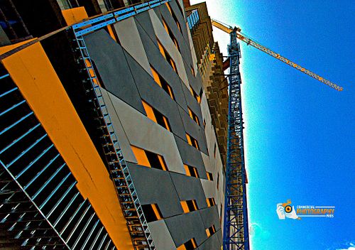 Tower crane elevating above a modern construction site.