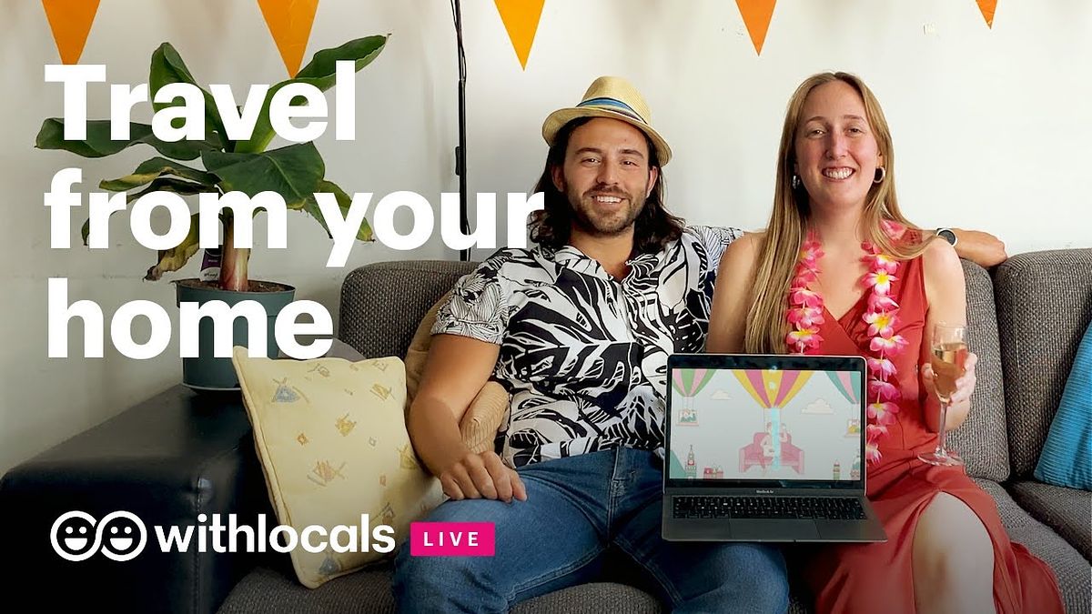 A woman and a man sitting on the couch smiling. The woman is holding a laptop to show Withlocals virtual tour on the screen. On top of the image lays Withlocals Live logo and "travel from your home) as text